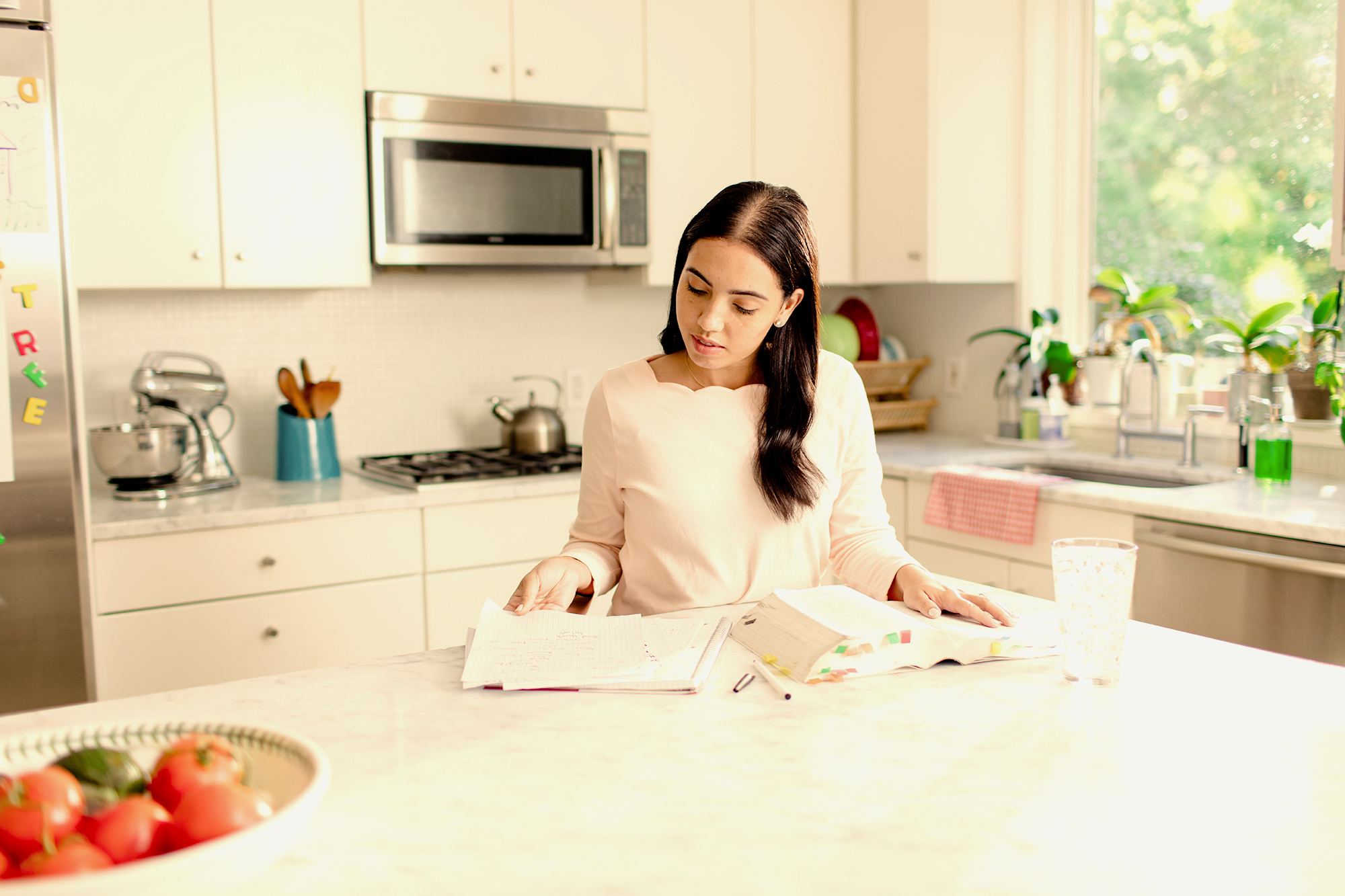 woman studying at kitchen counter