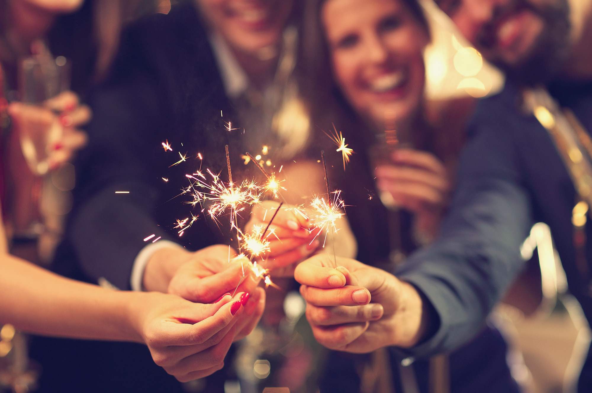 people celebrating with sparklers