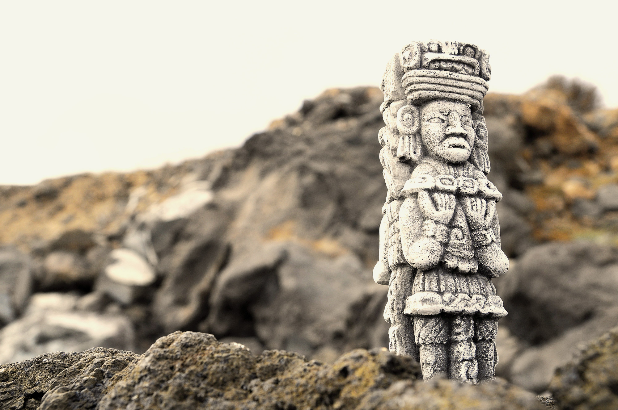 ancient Mayan statue on rocks