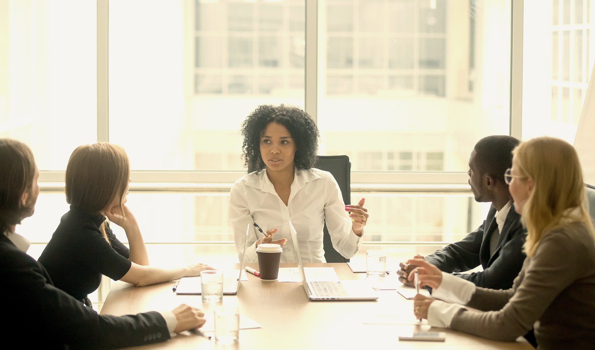 woman in management position holding meeting