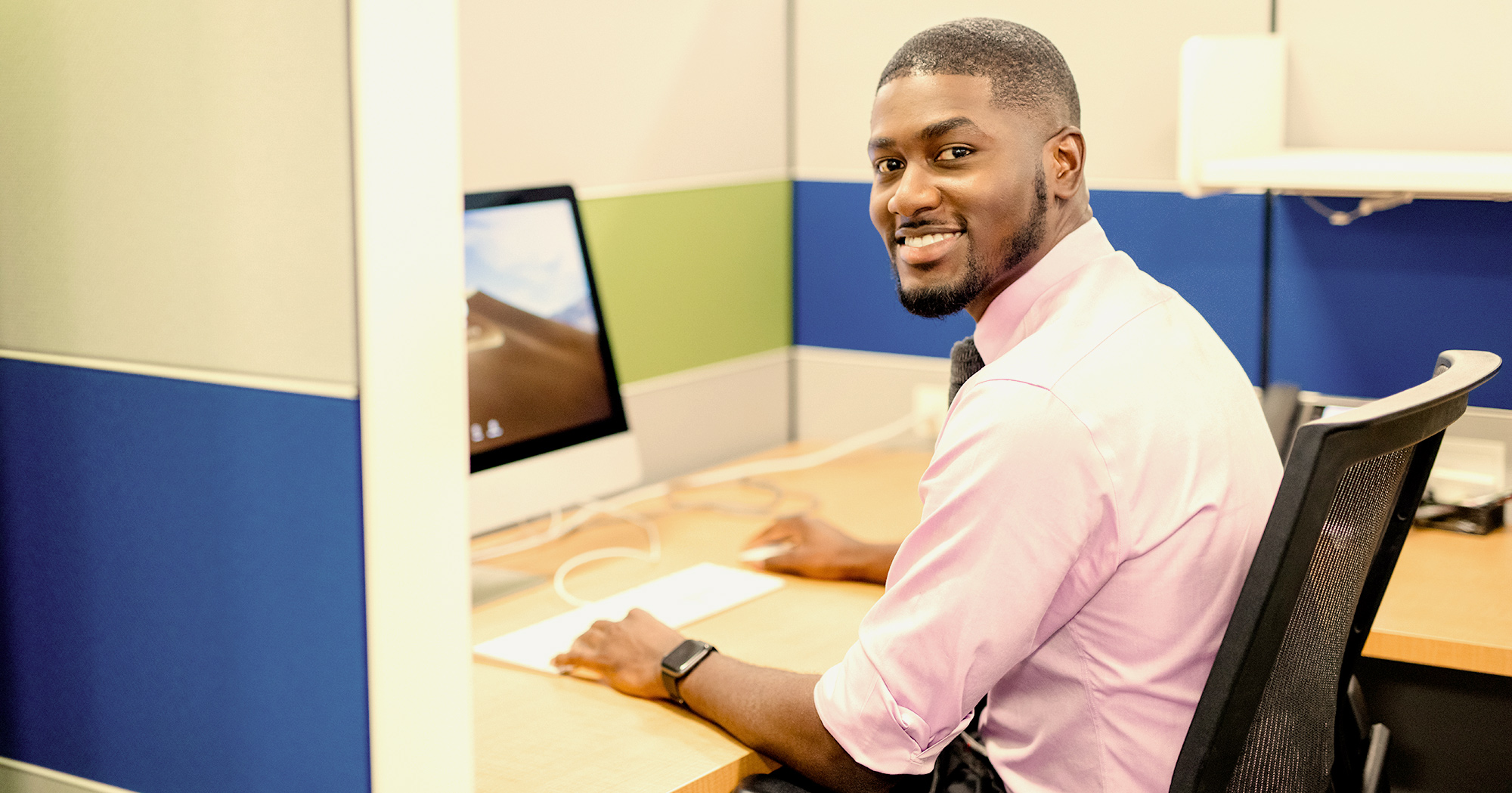 man sitting down working on laptop computer