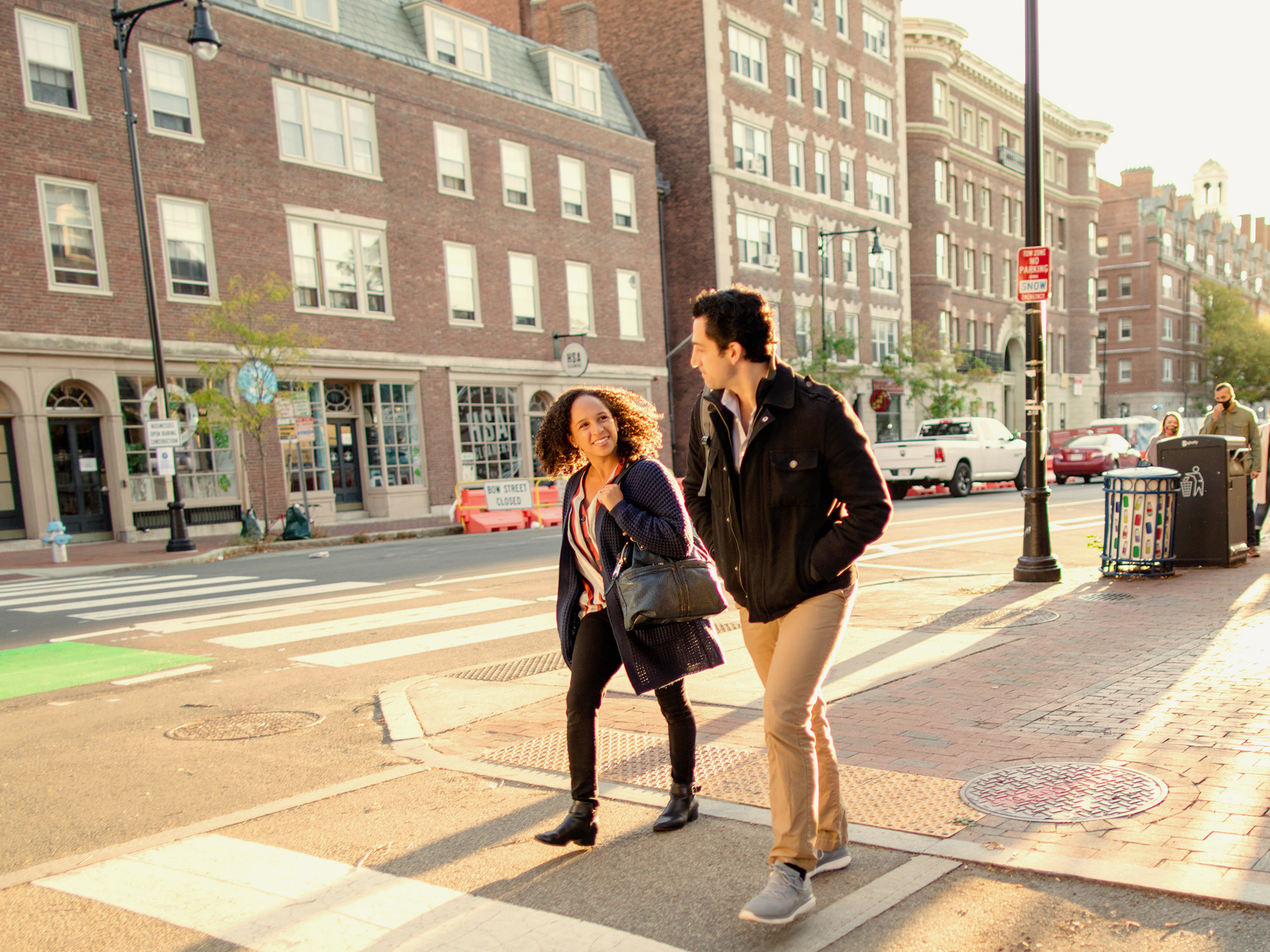 two students walking in crosswalk in Harvard Yard area