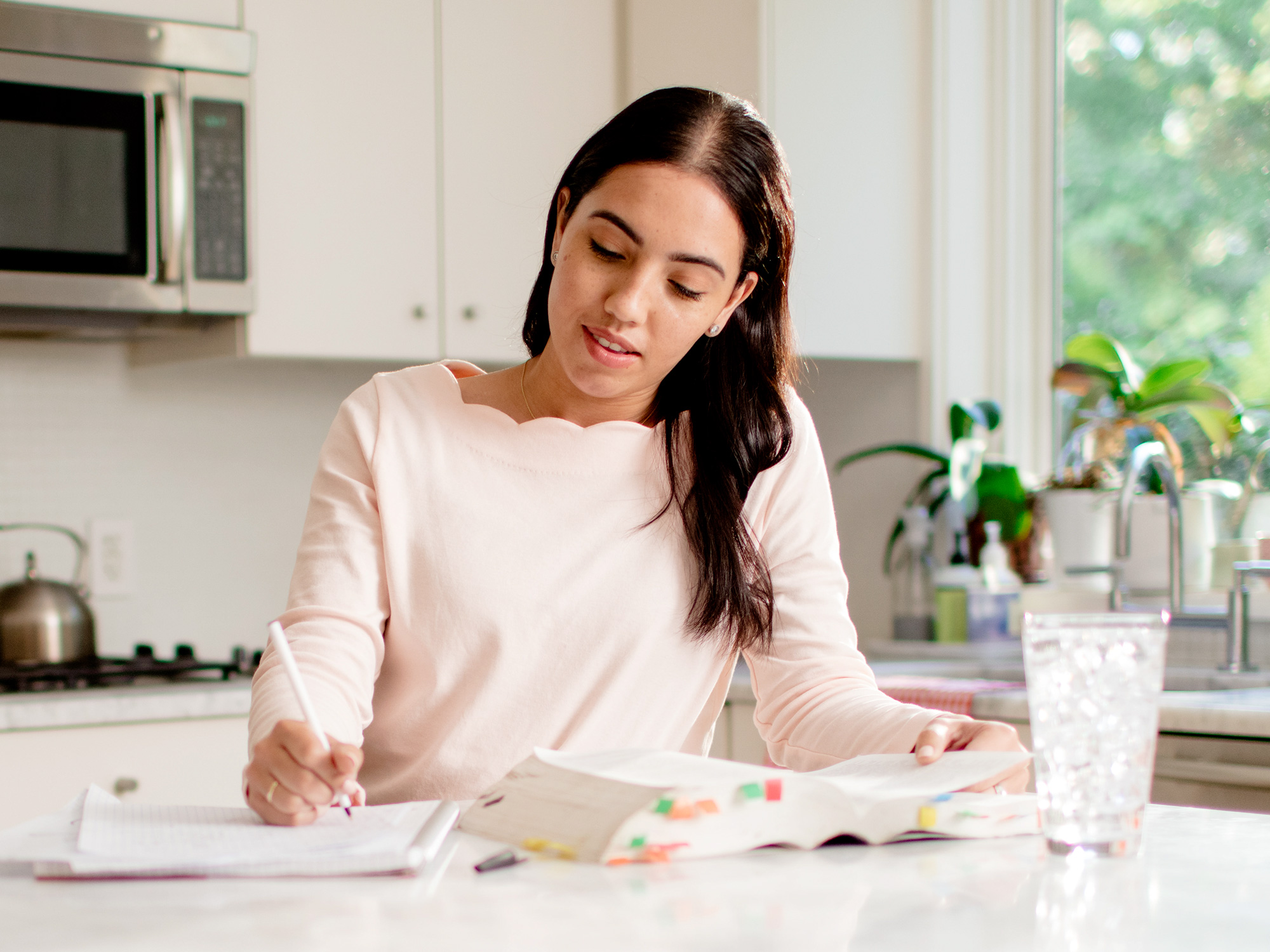 woman studying at kitchen counter