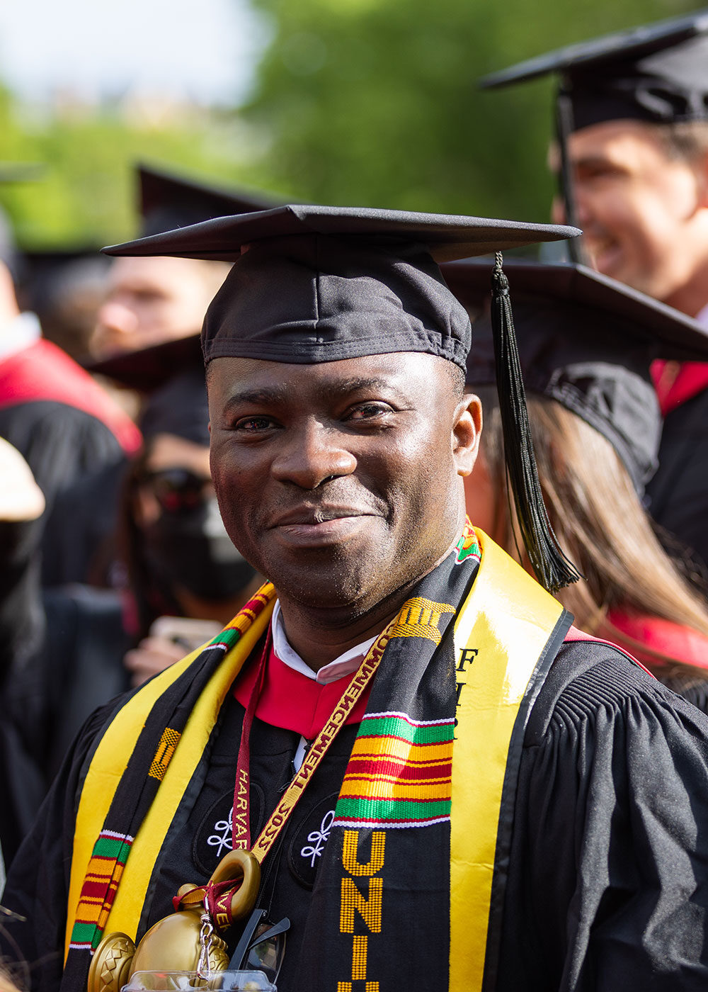 A smiling Extension School graduate at Harvard Commencement.