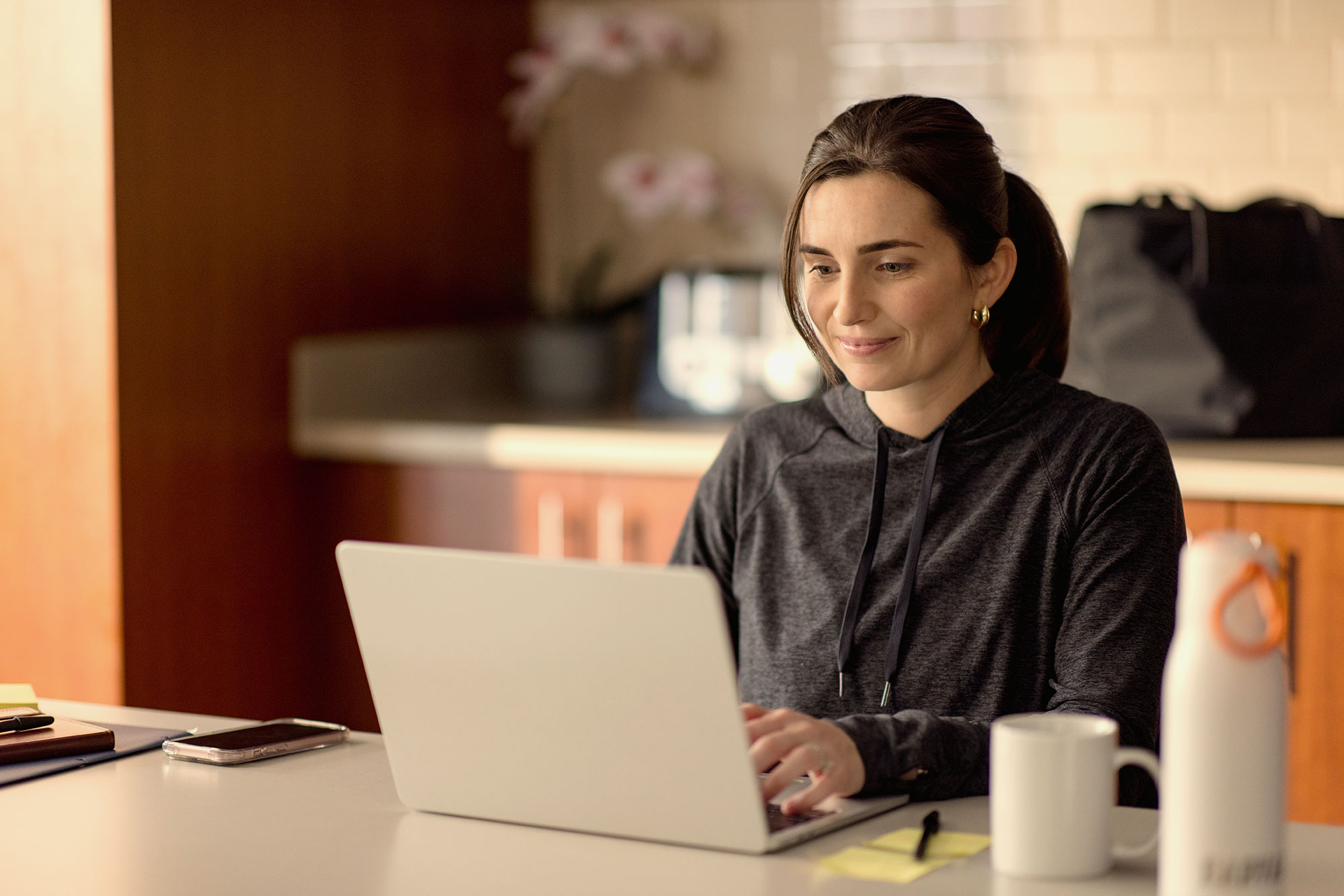 A Harvard Extension student works from her laptop.