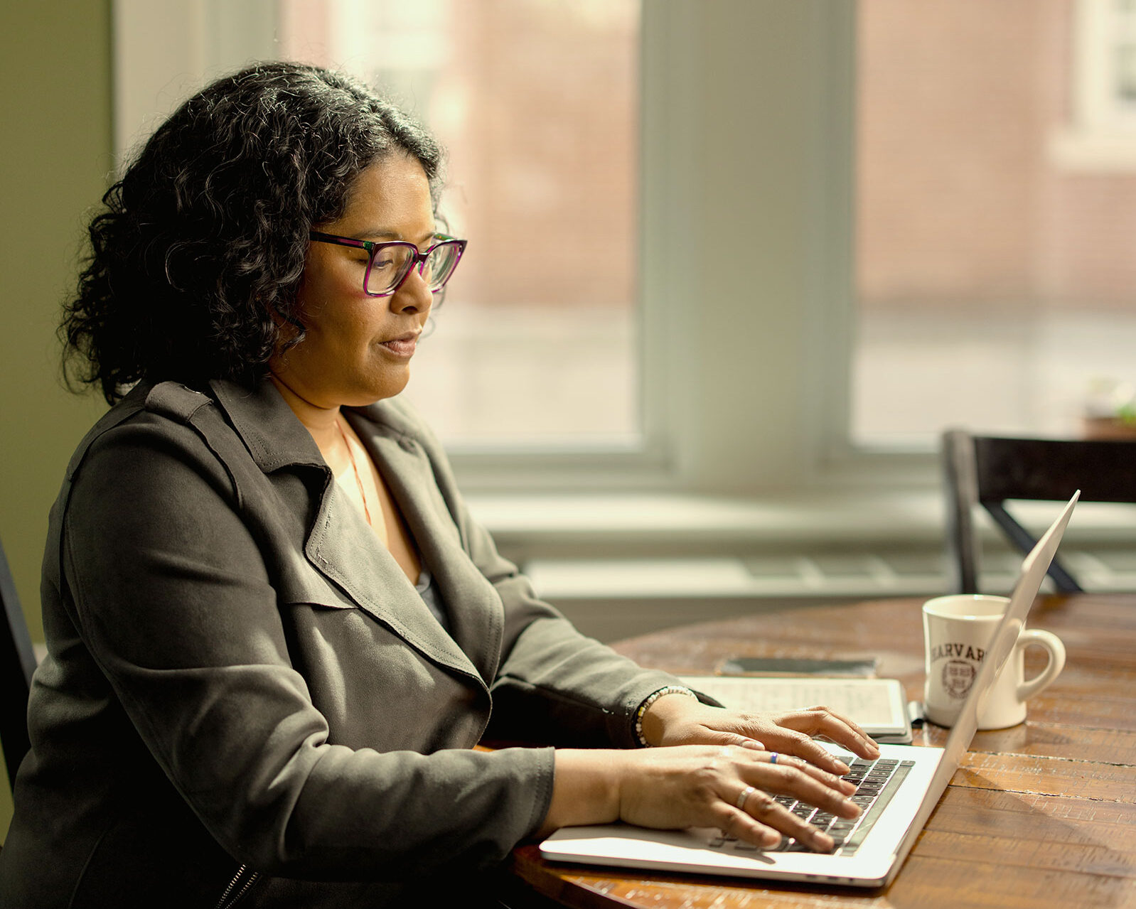A Harvard Extension student works on their laptop.