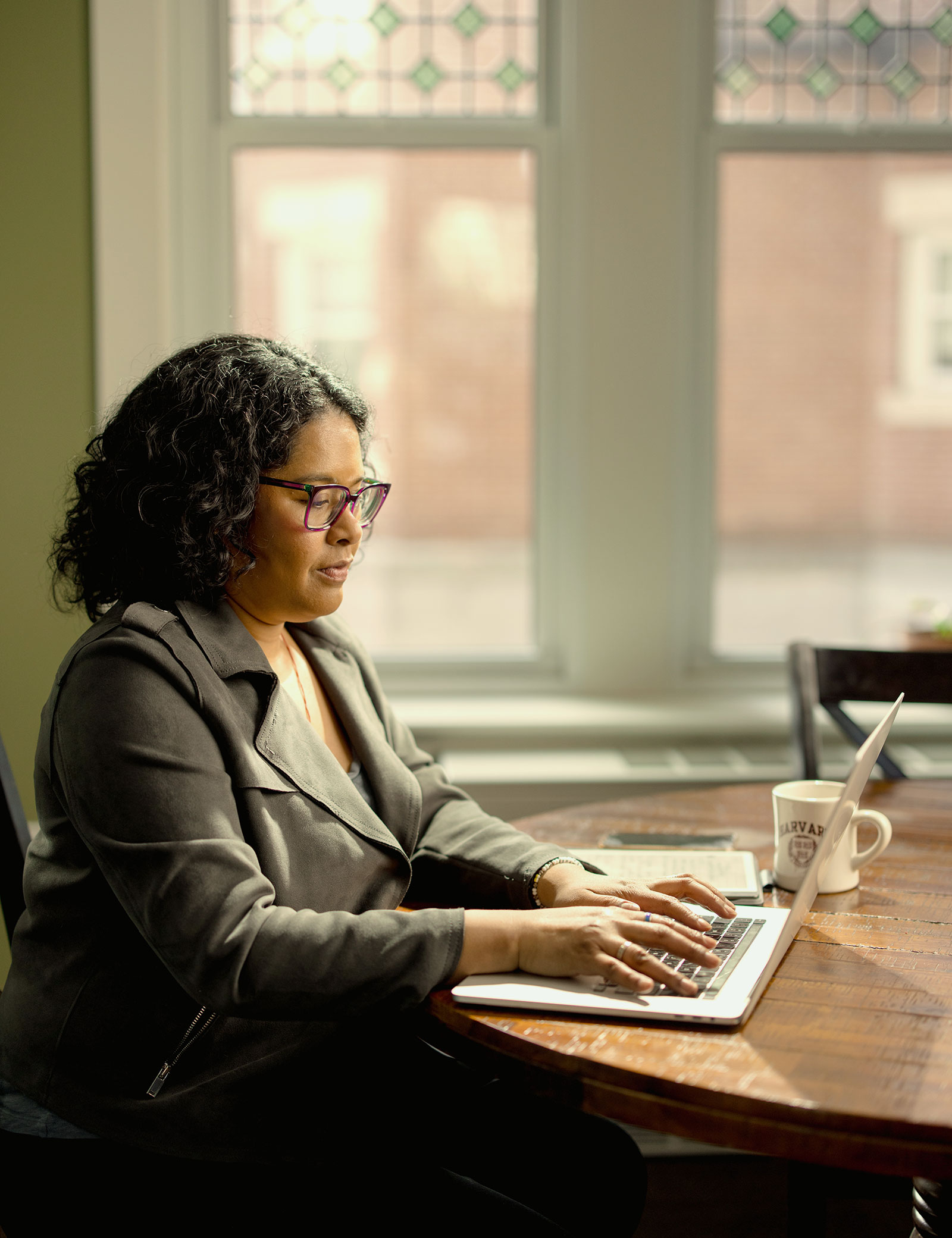 A Harvard Extension student works on their laptop.