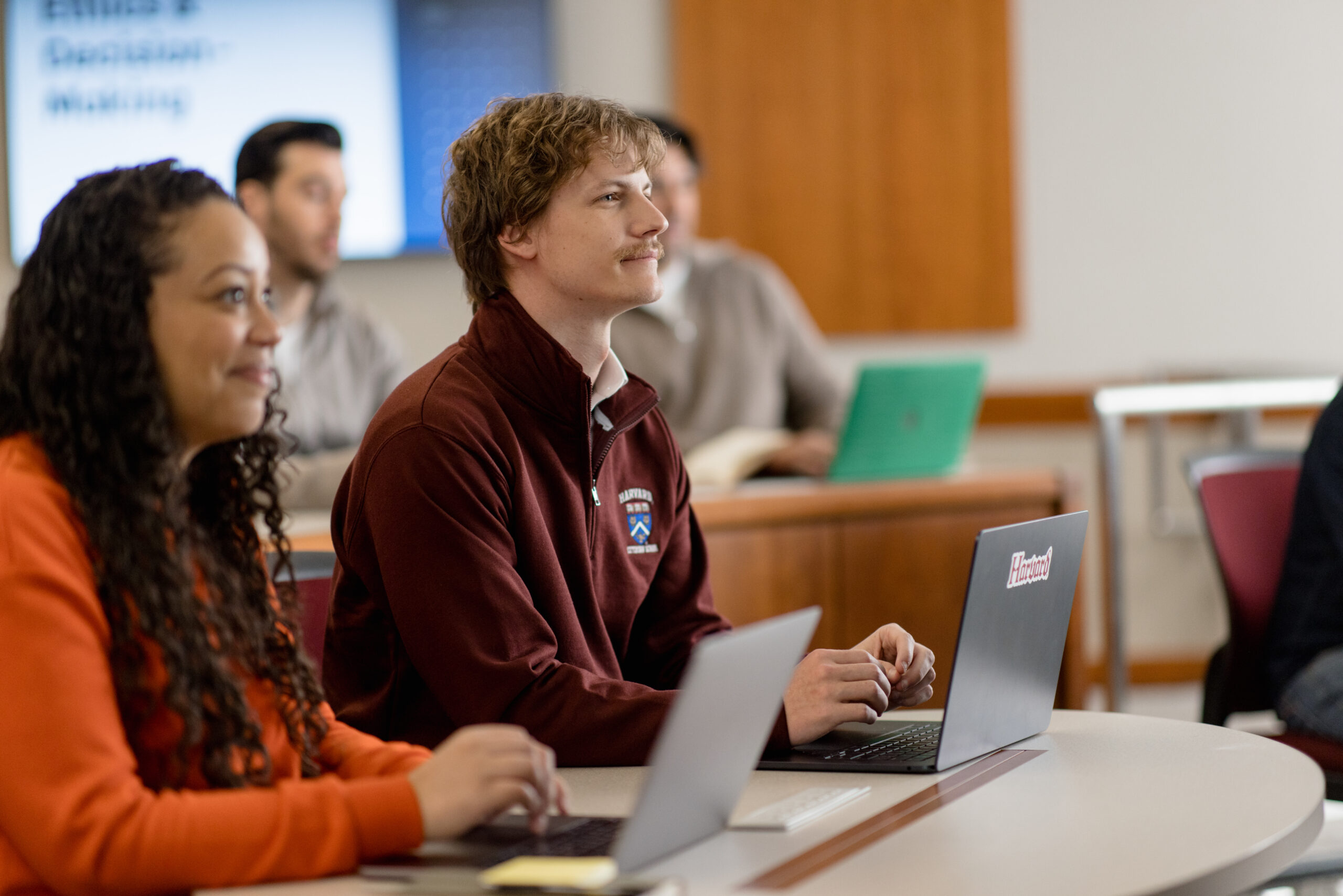 A group of Harvard Extension School students sits in a classroom.