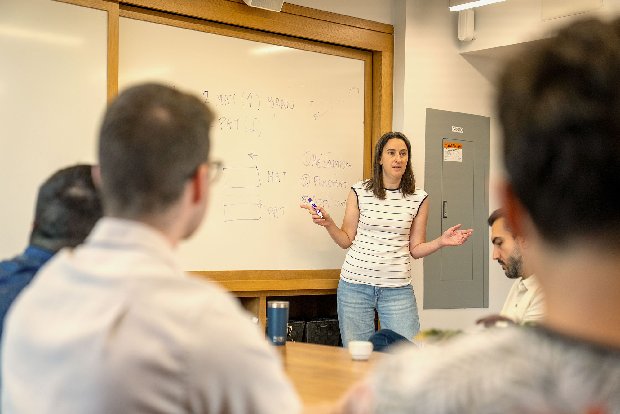 Harvard Extension School students listen to a lecture at the Harvard bio lab.