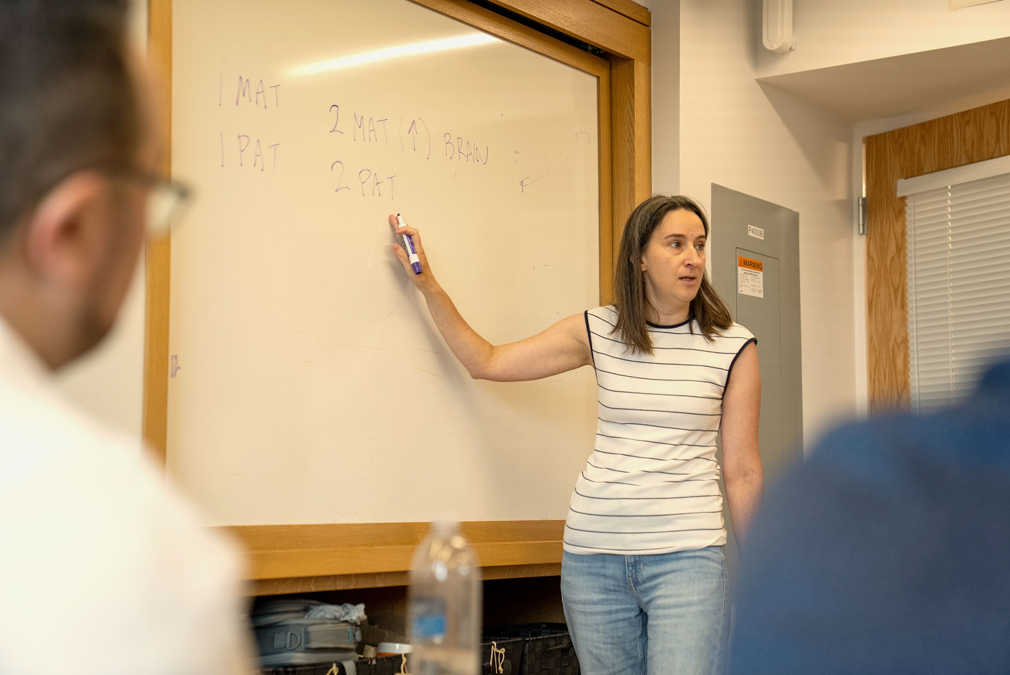 Harvard Extension School students listen to a lecture at the Harvard bio lab.
