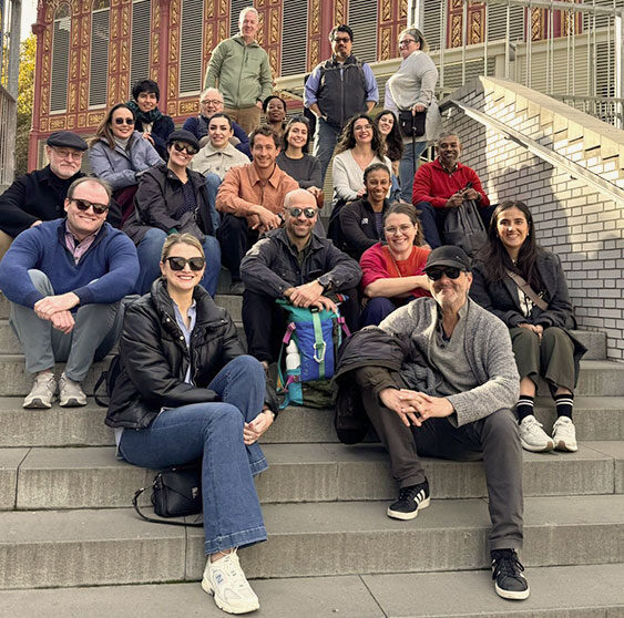 Students in the Global Consulting Practicum sitting on steps.