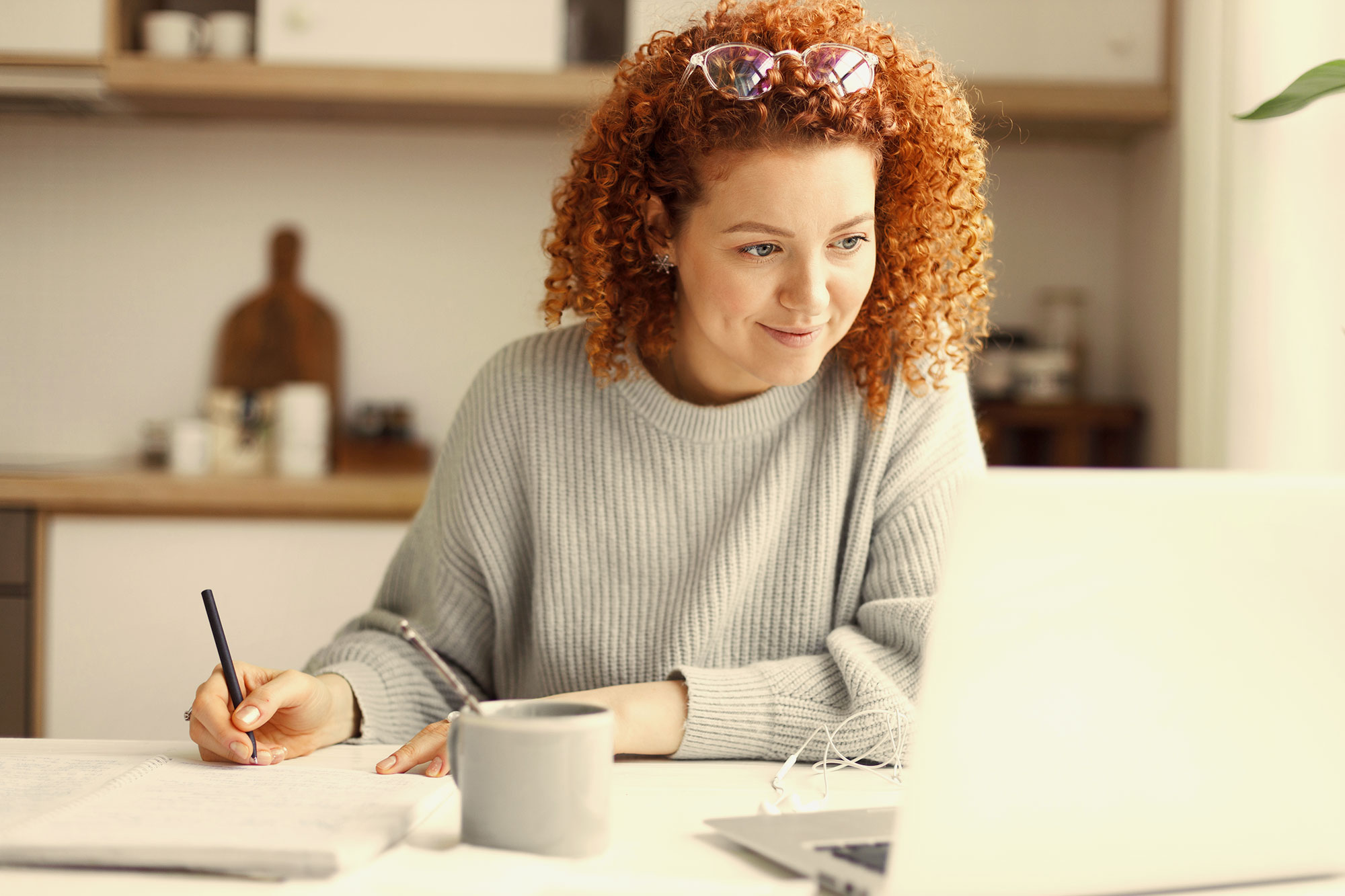 A woman studying in front of a laptop.