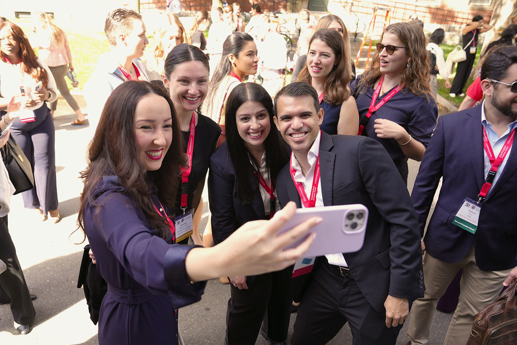 A group of Harvard Extension School students take a selfie at Convocation 2025.