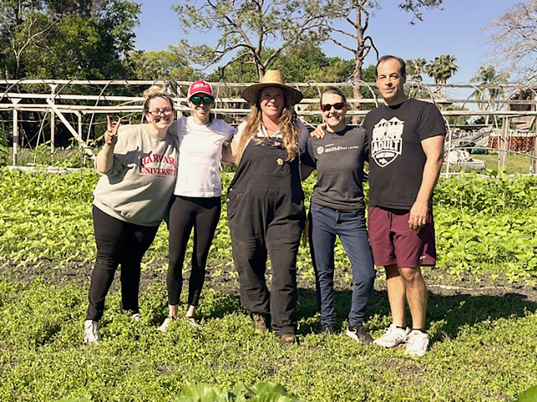 A group of Harvard Extension School students pose for a photo at a farm.
